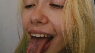 An amateur blonde teen with a perfect body as the barely legal cam girl shows off her spit in a homemade solo porn video.